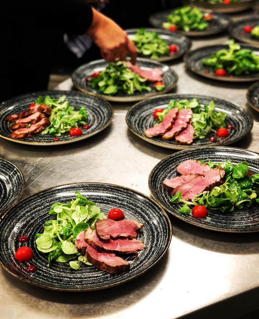 Plated slices of duck breast on lamb's lettuce from the Wagner kitchen